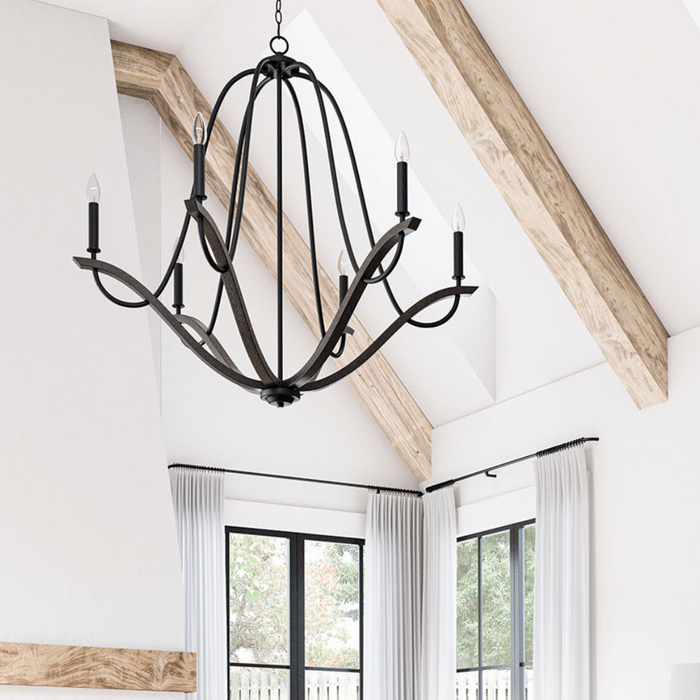 Capital Chandelier hanging in living room with vaulted ceiling and wood beams