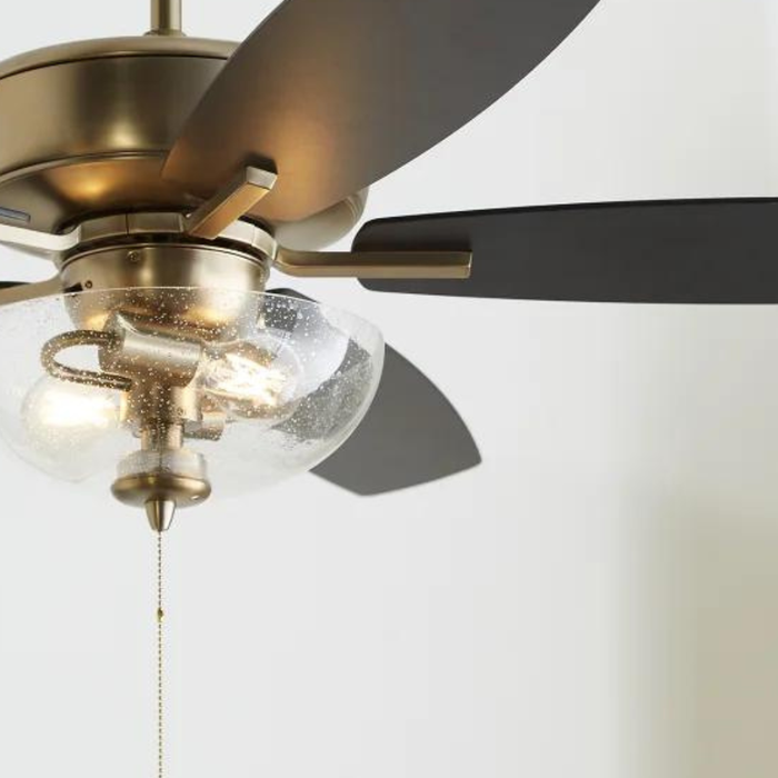 Close up of five blade, transitional-style, ceiling fan with a glass dome and two light bulbs
