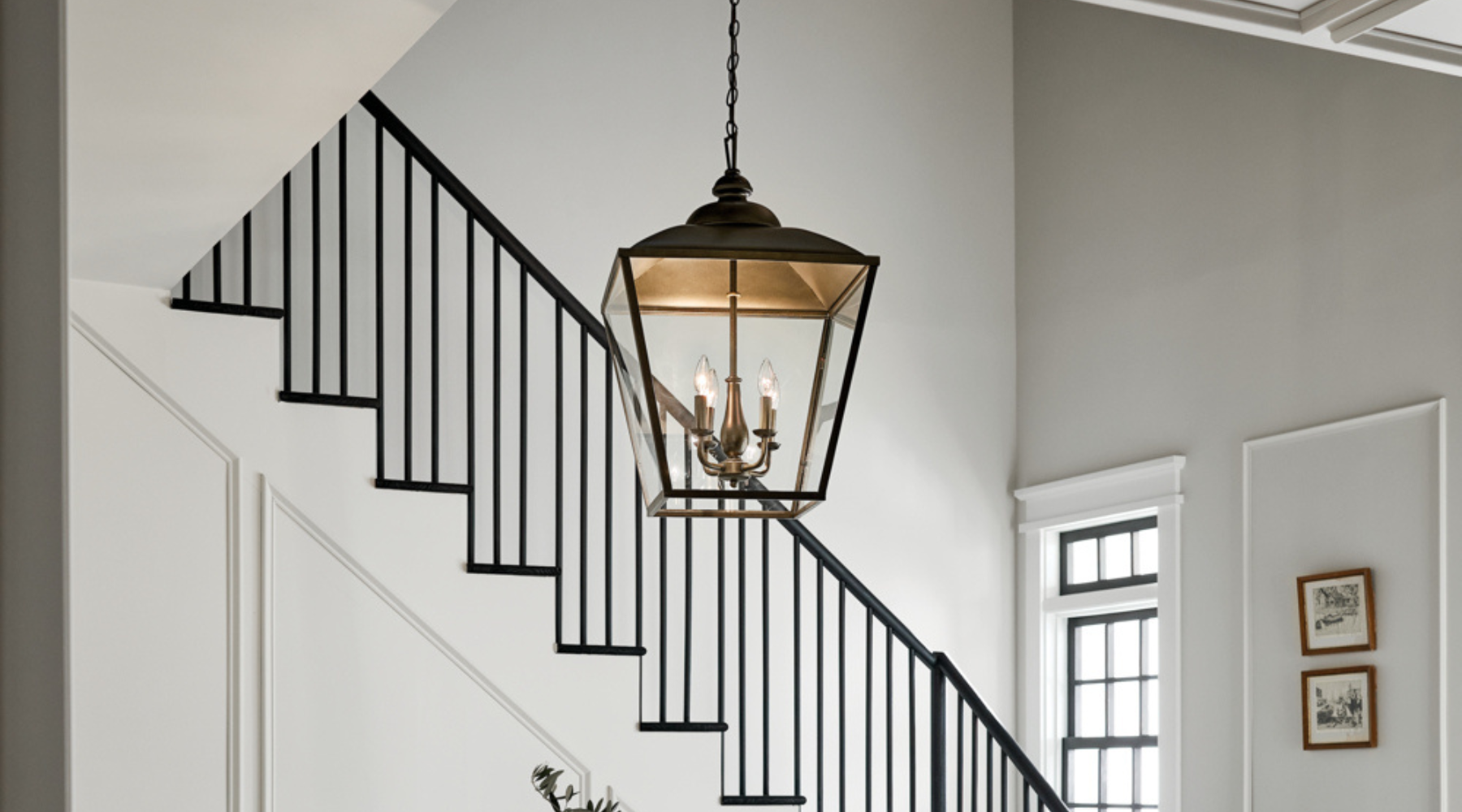 Black lantern in a tall home foyer