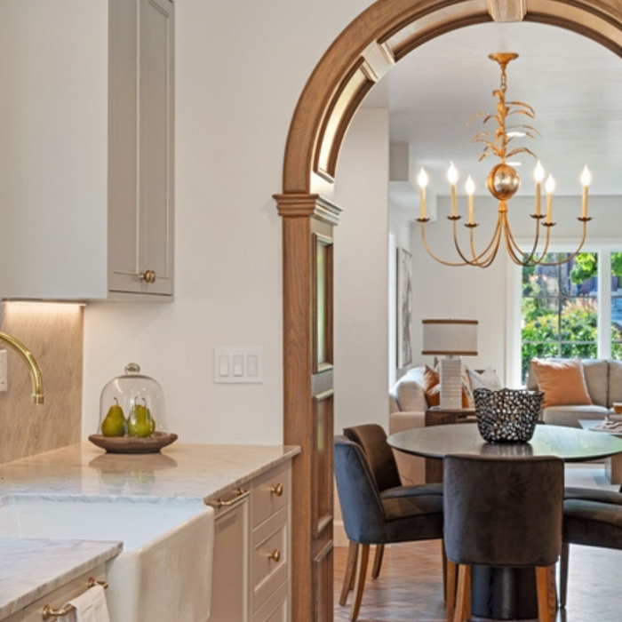 Arch showing a dining table and chandelier over the table