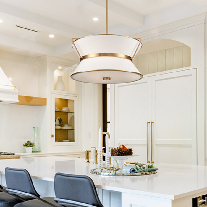 White kitchen with a single large pendant hanging over the island