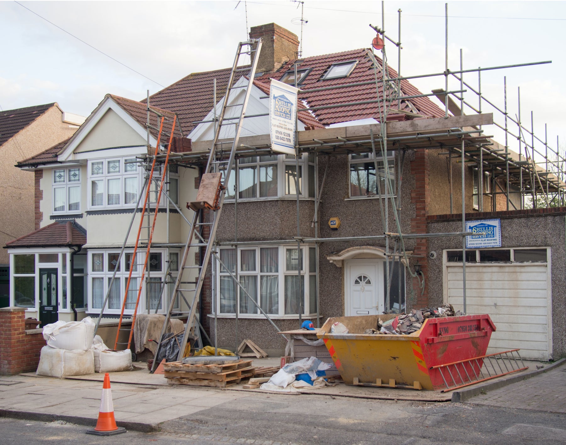 House undergoing construction with scaffolding around the home