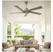 Ceiling fan in a sunlit outdoor living area with furniture and decor.