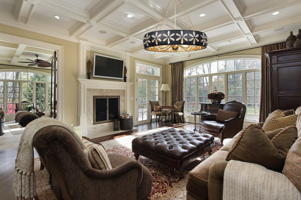 Living room with brown furniture, fireplace, and large windows.