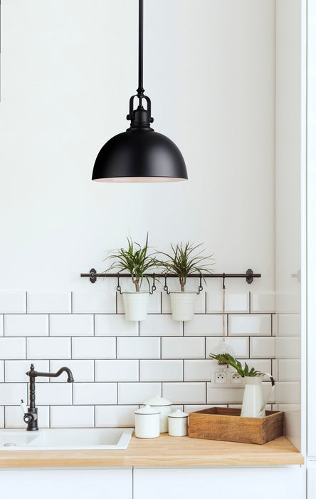 Modern kitchen with black pendant light, white subway tiles, and wooden countertop.