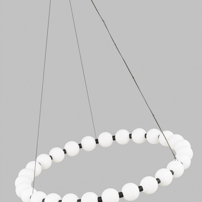 Close up image of a round contemporary modern chandelier with several globe shades. 