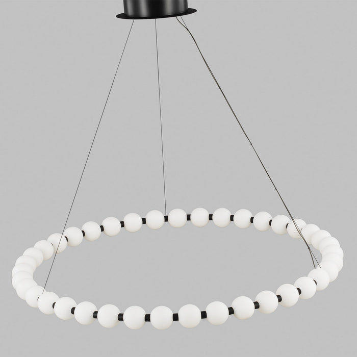 Circular chandelier with frosted globe lights suspended from a black ceiling mount by thin cables.