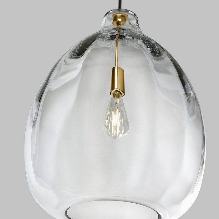Clear glass pendant with brass accents.