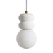 Modern pendant light with stacked white stone accents and a round frosted glass globe.