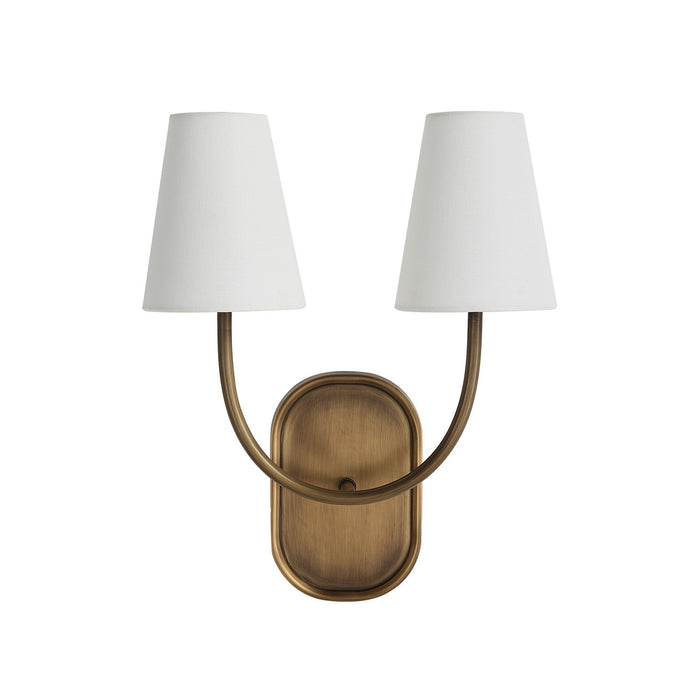 Brass double wall sconce with curved arms and white tapered fabric shades.