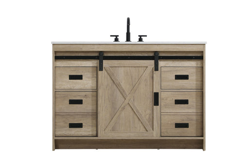 Light wood vanity with central barn door and surrounding drawers, top faucets visible.