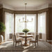 Dining room with a round wooden table, chairs, and a chandelier.