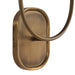 Close-up of an antique brass wall sconce backplate with curved metal arm detail.