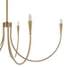 Close-up of a modern brass chandelier with curved arms and candle-style bulbs.