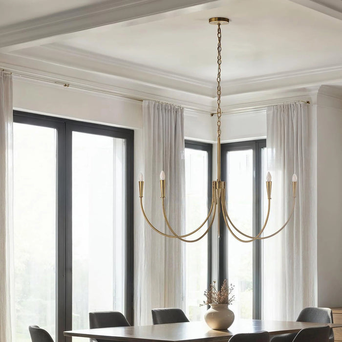 Elegant dining room with a modern brass chandelier, tall windows, and sheer white curtains.