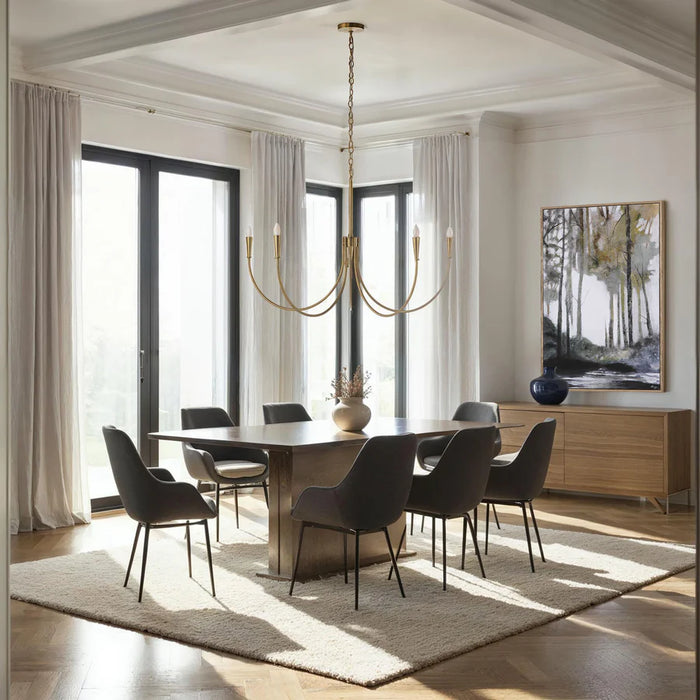 Bright modern dining room with a brass chandelier, large windows, and minimalist dark dining chairs.
