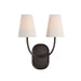Dark bronze double wall sconce with curved arms and white tapered fabric shades illuminated.