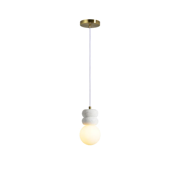 Modern pendant light with stacked white stone accents and an illuminated frosted glass globe.