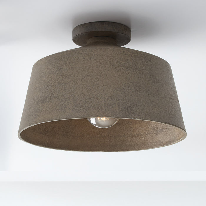 Bronze metal shade semi-flush hangs from a white ceiling