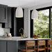 Modern kitchen with gray cabinets, white countertops, and wooden chairs.