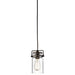 A single pendant light with a clear glass jar shade, an exposed filament bulb inside, and a dark metal cap and hanger. The light hangs from a black cord against a plain white background.
