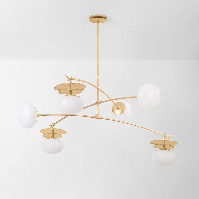 Modern chandelier with gold branches and white spherical lights on a light gray background
