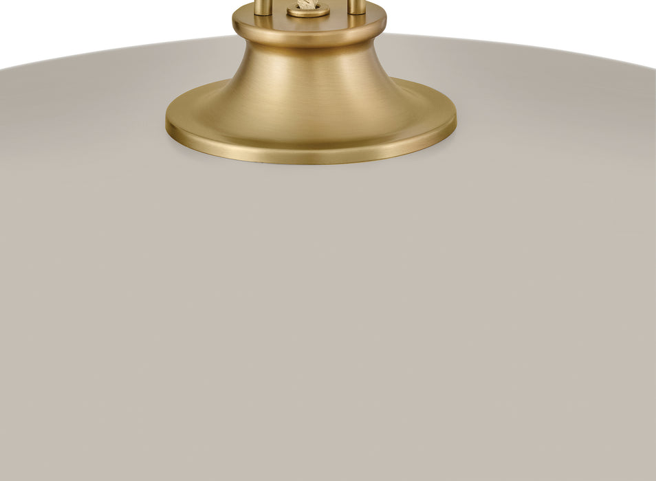 Close-up of a gold lampshade base on a white background