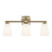 A three-light bathroom vanity light fixture with a brushed brass horizontal bar, a square backplate, and three tapered frosted glass shades, shown against a plain white background.
