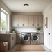 Modern laundry room with washing machine, dryer, and cabinets.