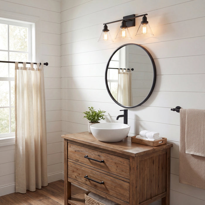 A rustic wooden bathroom vanity with a white vessel sink, a round black-framed mirror, and a three-light wall sconce in a bright shiplap bathroom.