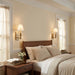 Neatly made bed in a bedroom with wooden headboard and nightstands.