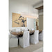 Linear glass chandelier hangs over dark wood table in modern dining room