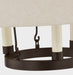 Close-up of a chandelier with black metal frame and white candle-like lights on a neutral background