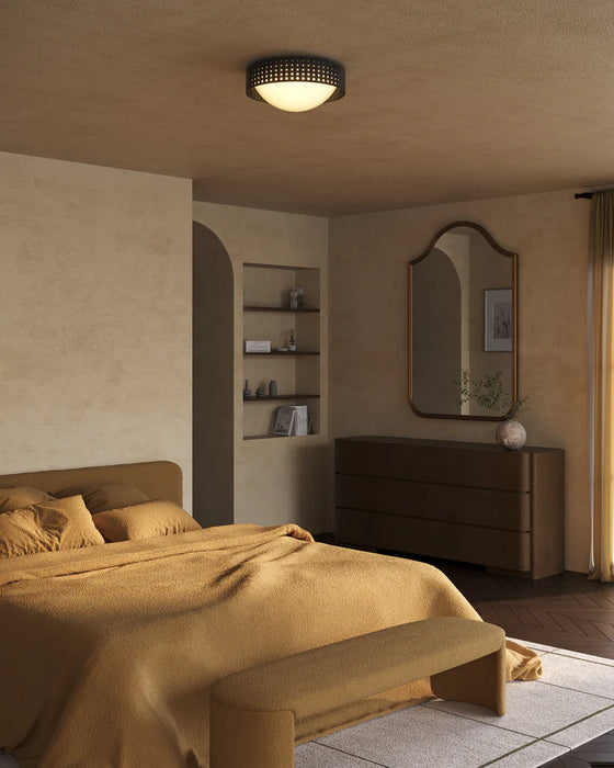Modern bedroom with a bed, dresser, and wall mirror.