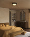 Modern bedroom with a bed, dresser, and wall mirror.