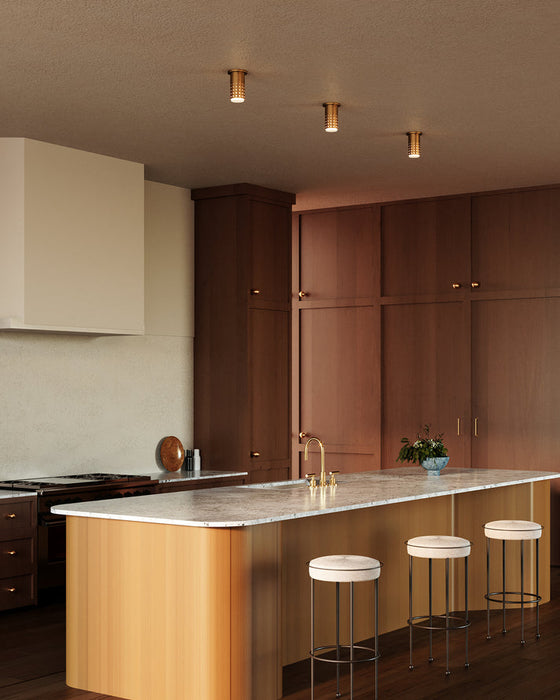 Modern kitchen with wooden cabinets, island, and bar stools.