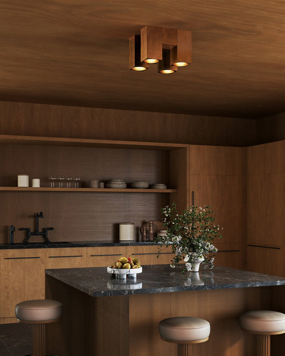 Modern kitchen with wooden cabinets, a marble island, and decorative elements.