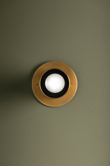 Round ceiling light fixture on a green ceiling