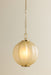 Gold pendant light with a beige glass shade on a neutral background