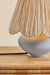 Table lamp with textured shade on a wooden surface