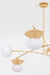 Modern chandelier with gold frame and white glass shades on a light gray background