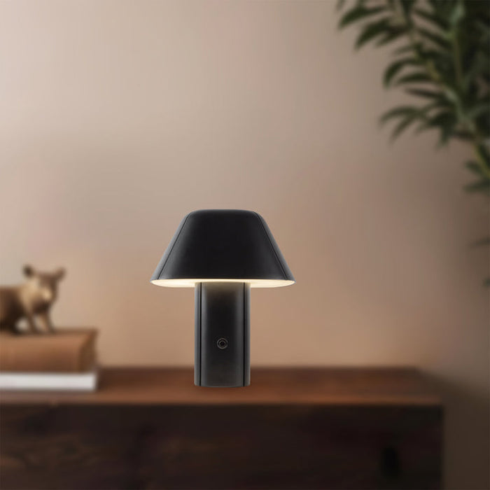 Black wall-mounted lamp on a wooden surface with a blurred background