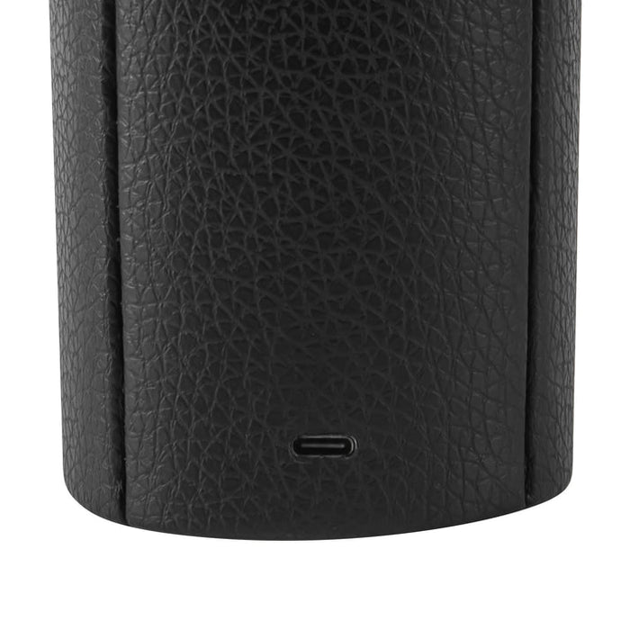 Close-up of a black textured lamp with a USB port on a white background