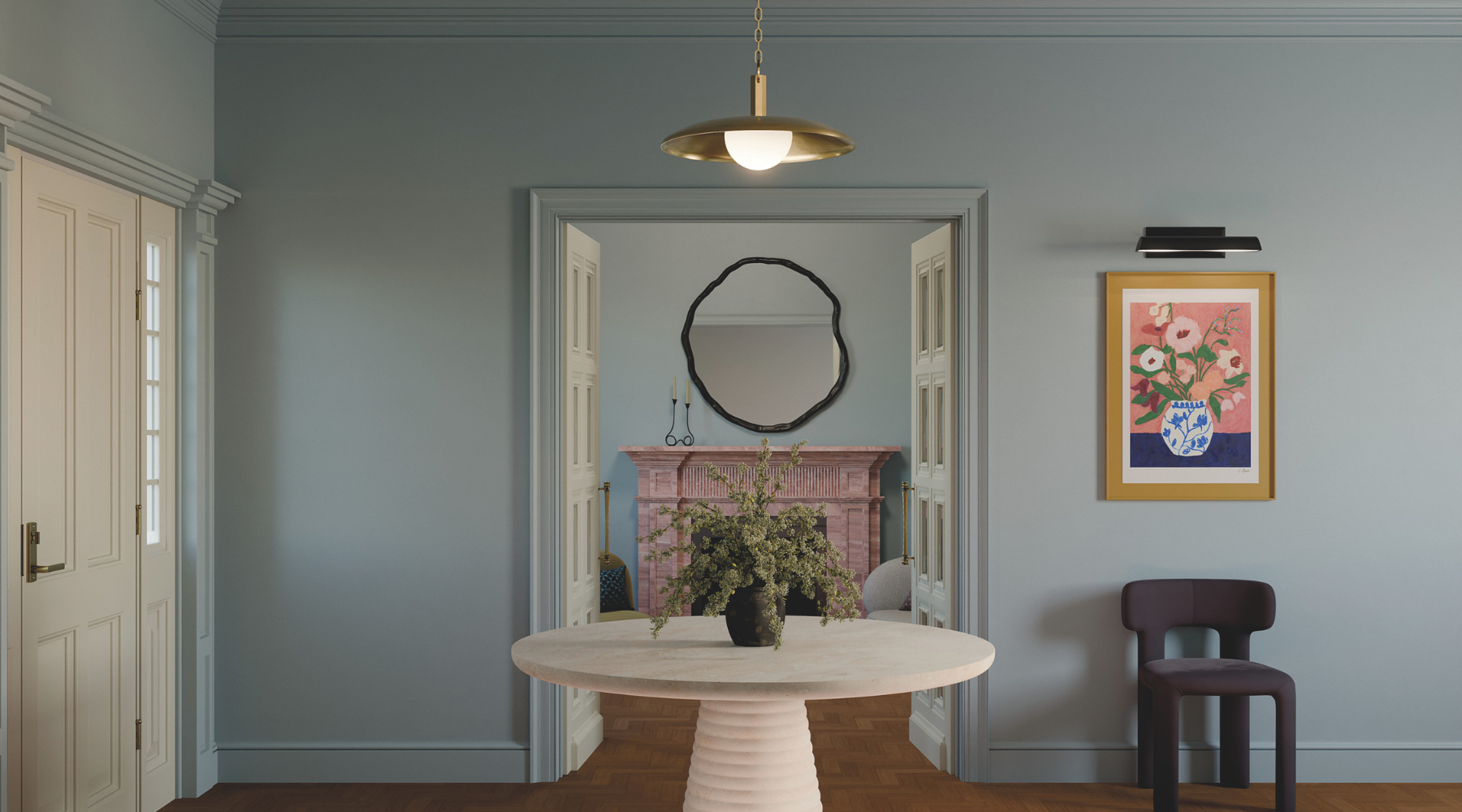 Dining room with a round table, chairs, and decorative elements on a gray wall.