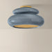 Ceiling light fixture with blue and gold design on a beige background