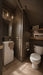 Bathroom with toilet and sink against a dark wall