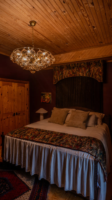 Bedroom with wooden ceiling and chandelier