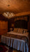 Bedroom with wooden ceiling and chandelier