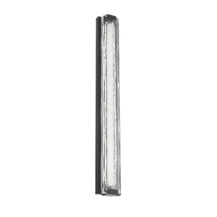 A modern rectangular wall light fixture with a textured clear glass panel and a slim dark metal frame, shown against a plain white background.