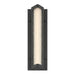 A modern rectangular wall light fixture with a matte black frame and a textured, frosted glass or acrylic front that glows with warm white light, shown against a plain white background.